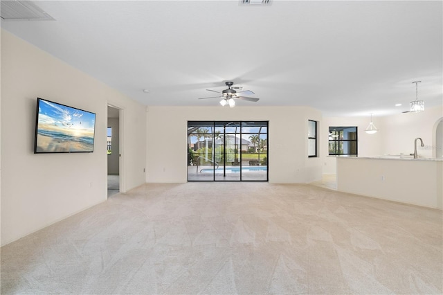 1457 Sea Fan Dr, Punta Gorda, FL 33950 - unfurnished living room featuring light carpet and ceiling fan