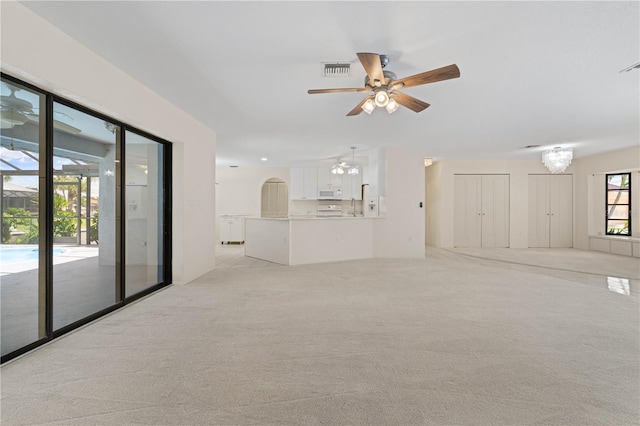 1457 Sea Fan Dr, Punta Gorda, FL 33950 - unfurnished living room featuring ceiling fan and light colored carpet