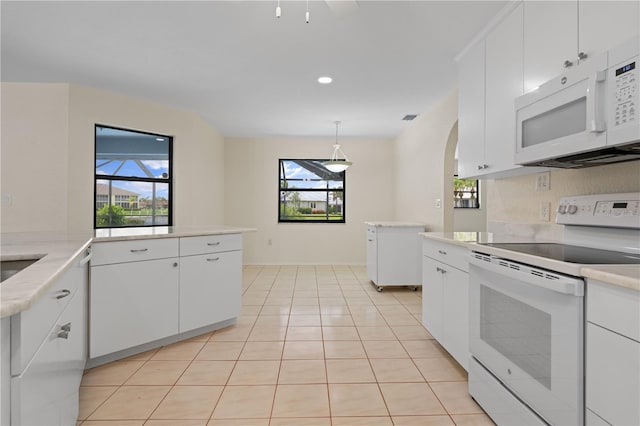1457 Sea Fan Dr, Punta Gorda, FL 33950 - kitchen with white appliances, light countertops, white cabinetry, arched walkways, and recessed lighting