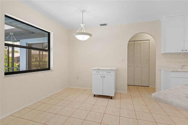 1457 Sea Fan Dr, Punta Gorda, FL 33950 - unfurnished dining area featuring light tile patterned floors and arched walkways