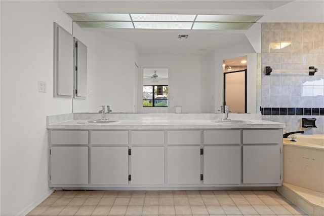 1457 Sea Fan Dr, Punta Gorda, FL 33950 - full bathroom with double vanity, a ceiling fan, a garden tub, and a shower