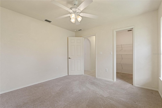 1457 Sea Fan Dr, Punta Gorda, FL 33950 - unfurnished bedroom featuring carpet floors, a spacious closet, and ceiling fan