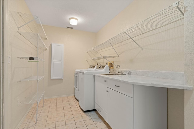 1457 Sea Fan Dr, Punta Gorda, FL 33950 - laundry room with washing machine and dryer, light tile patterned flooring, and cabinet space