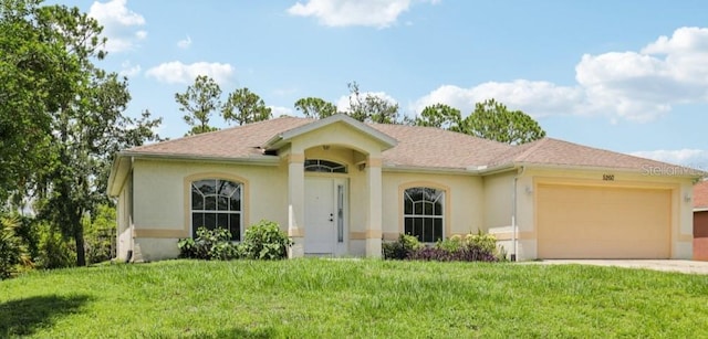 5260 Jessamine Ave, North Port, FL 34291 - view of front of house featuring stucco siding, an attached garage, a front lawn, and driveway