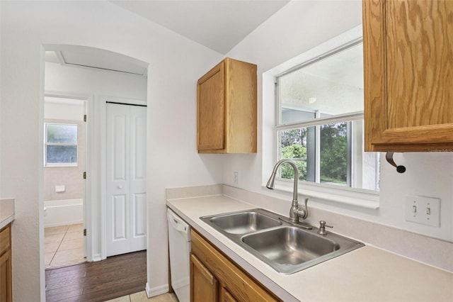 5260 Jessamine Ave, North Port, FL 34291 - kitchen with white dishwasher, light countertops, and brown cabinetry