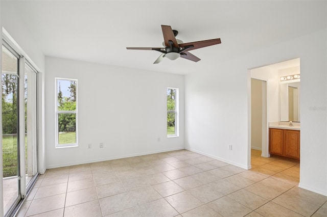 5260 Jessamine Ave, North Port, FL 34291 - unfurnished bedroom with light tile patterned flooring, ceiling fan, and ensuite bath