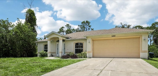 5260 Jessamine Ave, North Port, FL 34291 - single story home featuring stucco siding, driveway, an attached garage, and a front yard