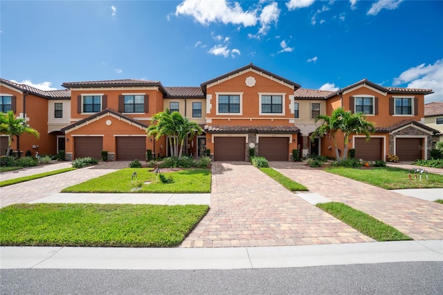 20333 Lagente Cir, Venice, FL 34293 - view of property featuring a tiled roof, stucco siding, a garage, and driveway