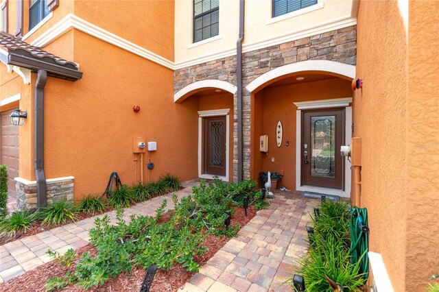 20333 Lagente Cir, Venice, FL 34293 - property entrance with stone siding and stucco siding