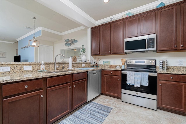 20333 Lagente Cir, Venice, FL 34293 - kitchen with stainless steel appliances, ornamental molding, light stone countertops, pendant lighting, and dark brown cabinets
