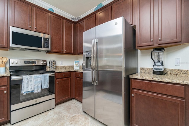 20333 Lagente Cir, Venice, FL 34293 - kitchen featuring appliances with stainless steel finishes, light stone counters, and light tile patterned floors