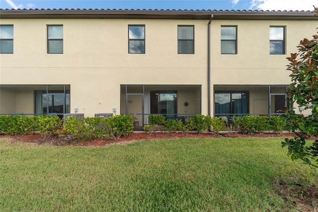20333 Lagente Cir, Venice, FL 34293 - rear view of property featuring stucco siding and a yard