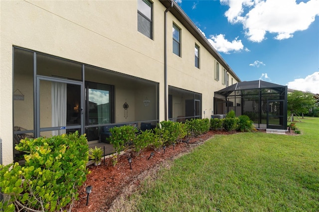 20333 Lagente Cir, Venice, FL 34293 - back of house with stucco siding, a yard, and a lanai