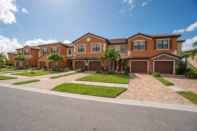 20333 Lagente Cir, Venice, FL 34293 - view of property with a tiled roof, driveway, an attached garage, and stucco siding