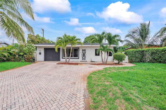 1541 NE 32nd Pl, Pompano Beach, FL 33064 - single story home with decorative driveway, stucco siding, a garage, and a front yard