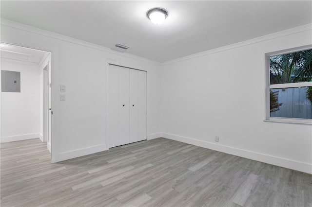 1541 NE 32nd Pl, Pompano Beach, FL 33064 - unfurnished bedroom with light wood-type flooring, electric panel, a closet, and crown molding