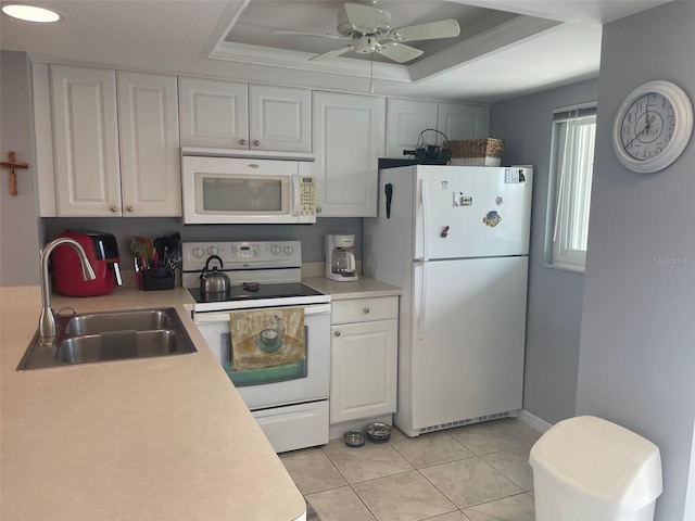 25275 Rampart Blvd Unit 207, Punta Gorda, FL 33983 - kitchen featuring white appliances, a tray ceiling, white cabinets, light countertops, and a ceiling fan
