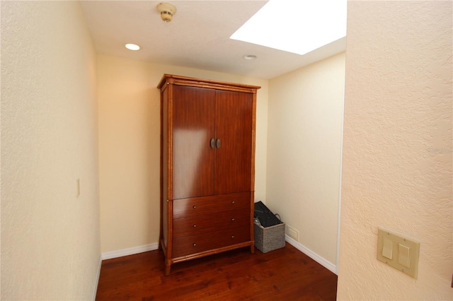 25188 Marion Ave Unit 24, Punta Gorda, FL 33950 - corridor featuring dark wood-style flooring, a skylight, recessed lighting, and a textured wall