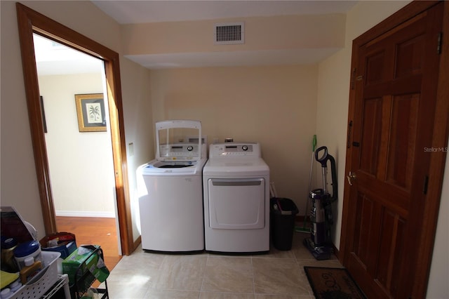 25188 Marion Ave Unit 24, Punta Gorda, FL 33950 - washroom featuring washing machine and clothes dryer and light tile patterned floors