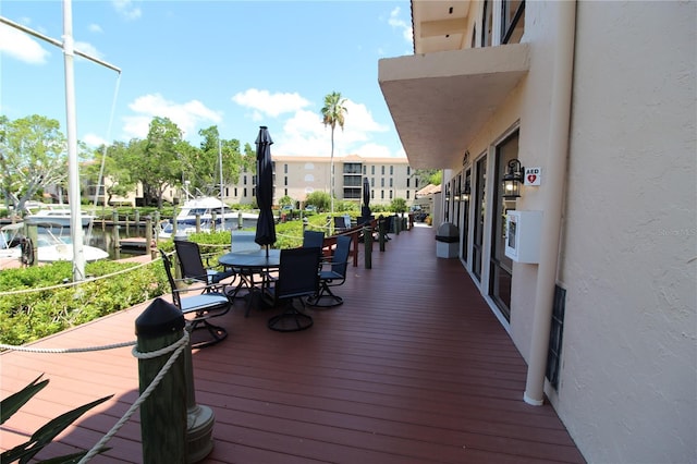 25188 Marion Ave Unit 24, Punta Gorda, FL 33950 - wooden terrace with outdoor dining area and a water view