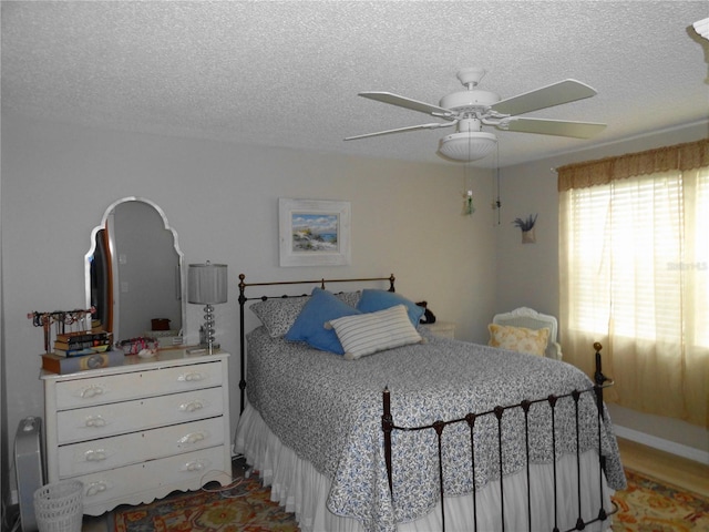 4022 Beaver Ln Unit 700B, Port Charlotte, FL 33952 - bedroom featuring a textured ceiling, ceiling fan, and wood finished floors