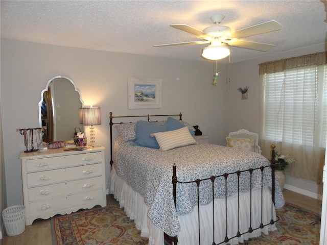 4022 Beaver Ln Unit 700B, Port Charlotte, FL 33952 - bedroom with wood finished floors, a textured ceiling, and a ceiling fan