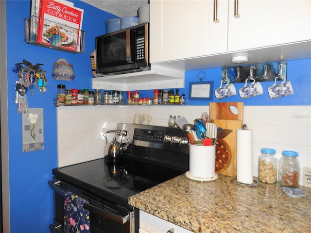 4022 Beaver Ln Unit 700B, Port Charlotte, FL 33952 - kitchen with electric stove, decorative backsplash, extractor fan, white cabinets, and light stone countertops