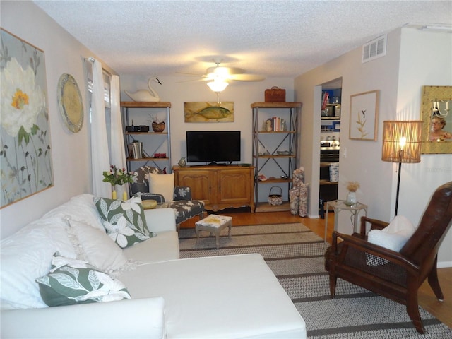 4022 Beaver Ln Unit 700B, Port Charlotte, FL 33952 - living room with a ceiling fan, a textured ceiling, and wood finished floors