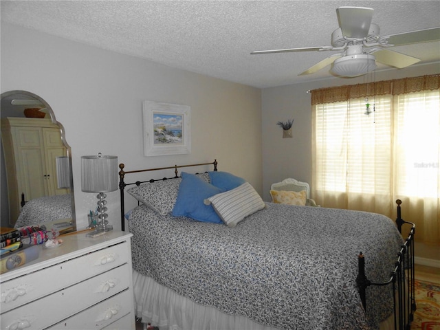 4022 Beaver Ln Unit 700B, Port Charlotte, FL 33952 - bedroom featuring a textured ceiling and a ceiling fan