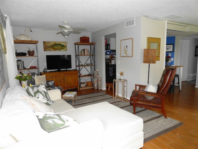 4022 Beaver Ln Unit 700B, Port Charlotte, FL 33952 - living area with wood finished floors, a ceiling fan, and a textured ceiling