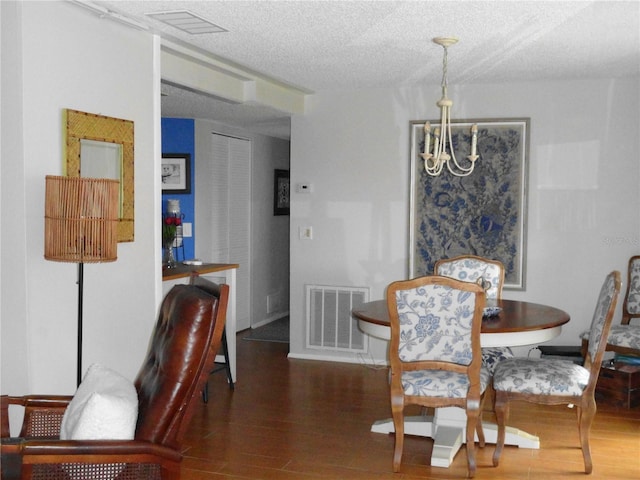 4022 Beaver Ln Unit 700B, Port Charlotte, FL 33952 - dining area with wood finished floors, a chandelier, and a textured ceiling