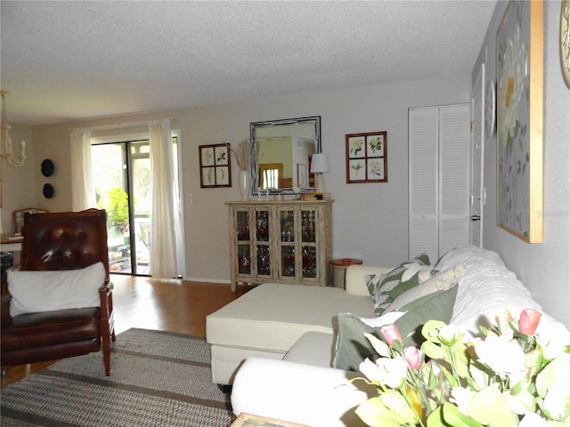 4022 Beaver Ln Unit 700B, Port Charlotte, FL 33952 - living room with wood finished floors, a chandelier, and a textured ceiling