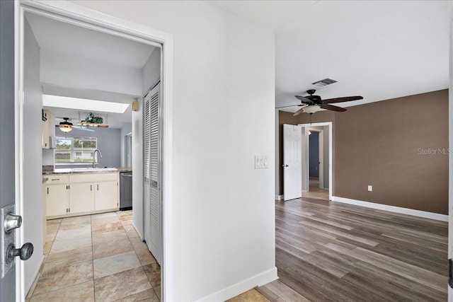 572 Darwin Rd, Venice, FL 34293 - corridor with a sink and light wood-style flooring