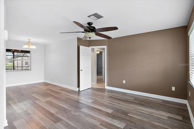 572 Darwin Rd, Venice, FL 34293 - spare room featuring a chandelier, wood finished floors, and ceiling fan