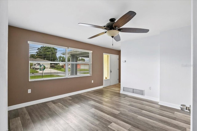 572 Darwin Rd, Venice, FL 34293 - empty room with ceiling fan and wood finished floors