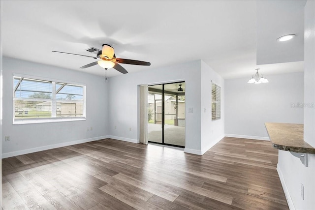 572 Darwin Rd, Venice, FL 34293 - empty room featuring a chandelier, dark wood-style floors, and ceiling fan