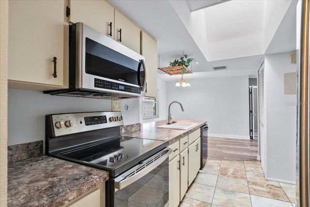 572 Darwin Rd, Venice, FL 34293 - kitchen with appliances with stainless steel finishes, dark countertops, and cream cabinets