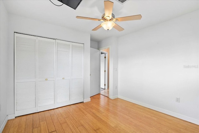 572 Darwin Rd, Venice, FL 34293 - unfurnished bedroom featuring wood finished floors, a closet, and a ceiling fan