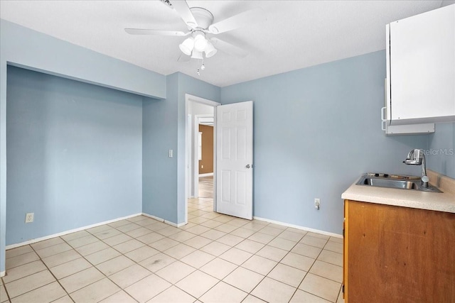 572 Darwin Rd, Venice, FL 34293 - kitchen with ceiling fan, light countertops, light tile patterned floors, and white cabinets