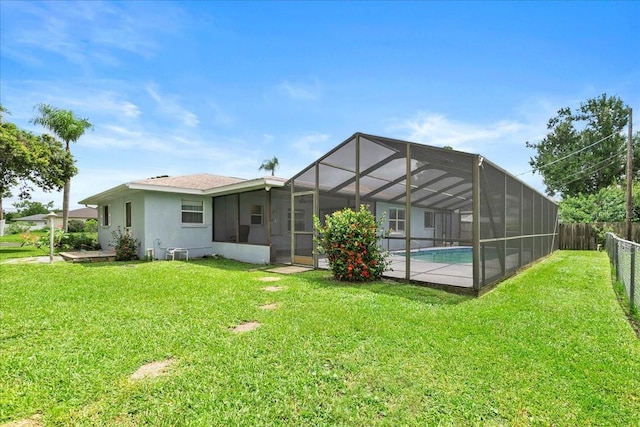 572 Darwin Rd, Venice, FL 34293 - back of house featuring a fenced backyard, stucco siding, and a lanai