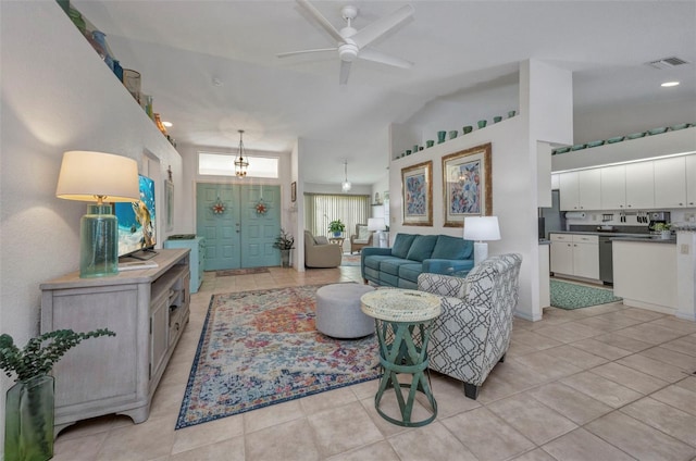 860 Silver Springs Ter NW, Port Charlotte, FL 33948 - living room featuring ceiling fan, light tile patterned floors, and vaulted ceiling