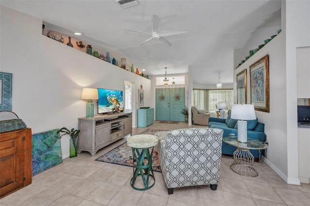 860 Silver Springs Ter NW, Port Charlotte, FL 33948 - living room with a ceiling fan, light tile patterned floors, and vaulted ceiling