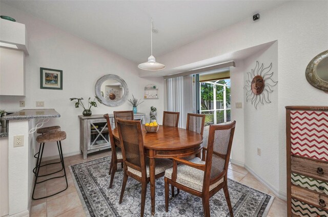 860 Silver Springs Ter NW, Port Charlotte, FL 33948 - dining area with light tile patterned floors and baseboards
