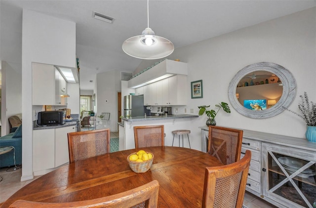 860 Silver Springs Ter NW, Port Charlotte, FL 33948 - dining area with light tile patterned floors and lofted ceiling