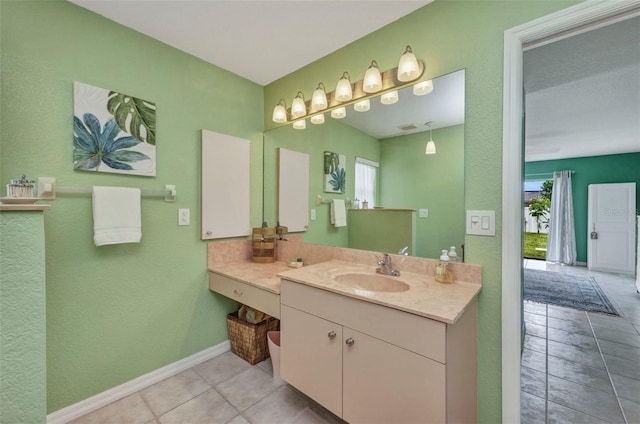 860 Silver Springs Ter NW, Port Charlotte, FL 33948 - bathroom featuring healthy amount of natural light, tile patterned floors, vanity, and a textured wall