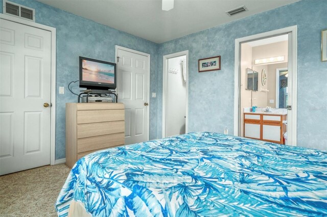 2103 Villaway E, Sebring, FL 33876 - carpeted bedroom with connected bathroom and ceiling fan