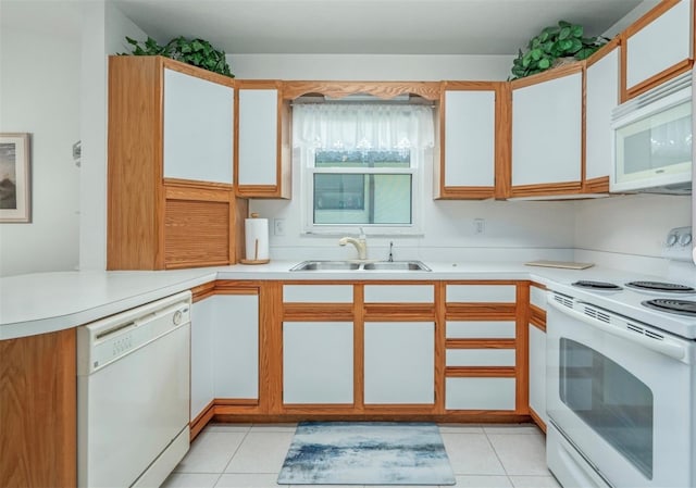 2103 Villaway E, Sebring, FL 33876 - kitchen featuring white appliances, light countertops, light tile patterned floors, and a peninsula