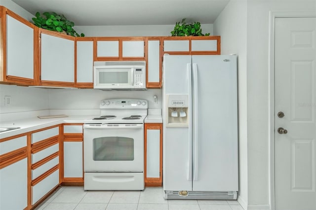 2103 Villaway E, Sebring, FL 33876 - kitchen with white appliances, light countertops, and light tile patterned floors