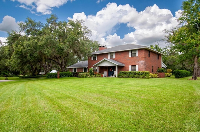 3990 NE Ashley Ter, Arcadia, FL 34266 - rear view of property featuring a yard, brick siding, and a chimney