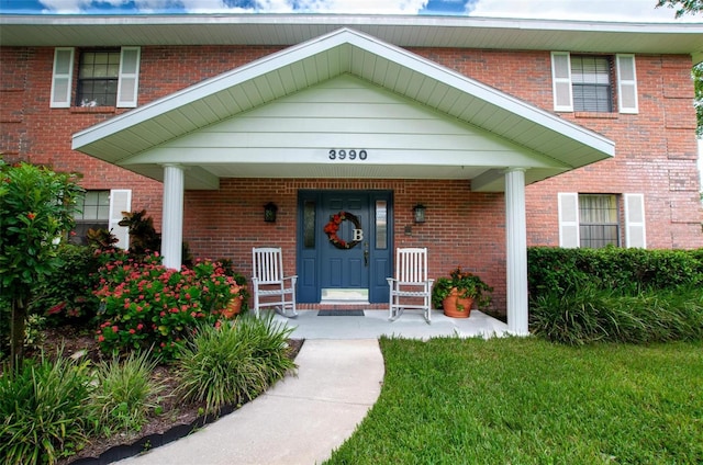3990 NE Ashley Ter, Arcadia, FL 34266 - view of exterior entry with covered porch and brick siding